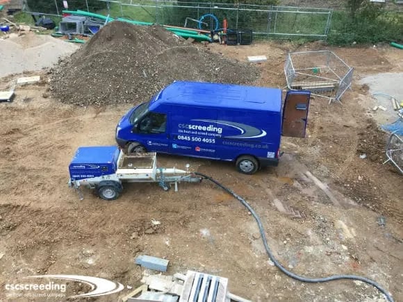 The screed pump has to be carefully located to receive screed from large trucks
