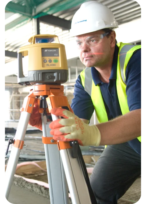 A man using screed testing equipment to make sure the house screed is perfect